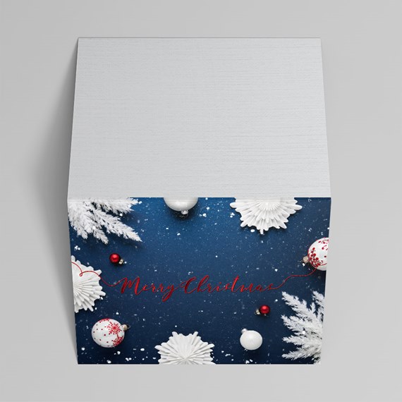 Square holiday gift box with white wood lid and navy front decorated with snowflakes, red and white baubles and 'Merry Christmas' text
