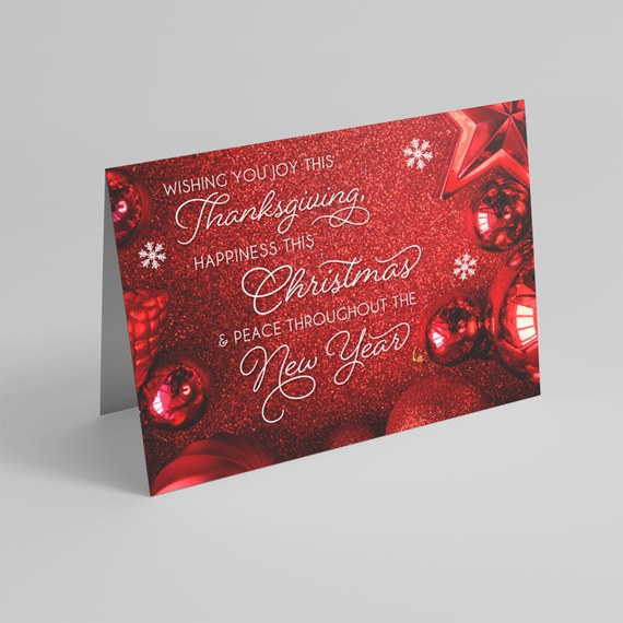 glittery red holiday card with ornaments and text