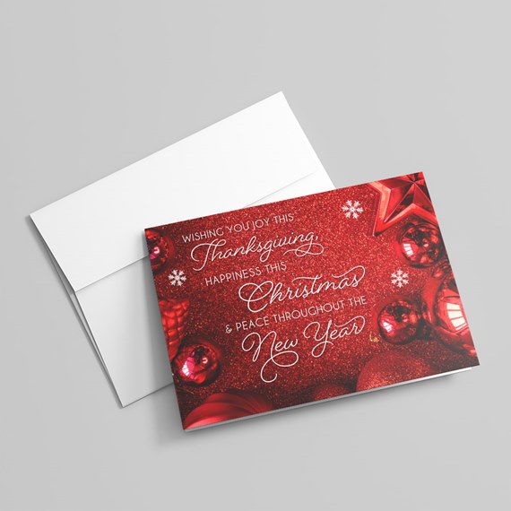 holiday greeting card with red glitter background and ornaments