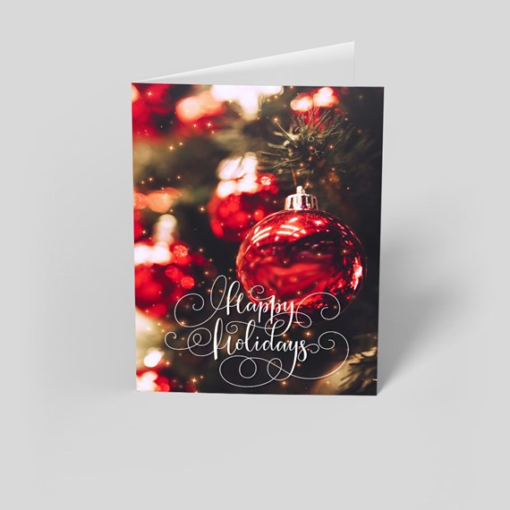 holiday card with red ornament and happy holidays text