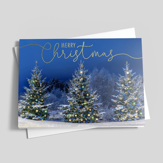 holiday card with snow-covered trees and gold text