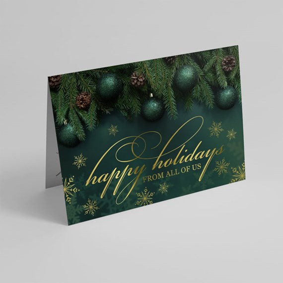 holiday card with green ornaments and pine branches