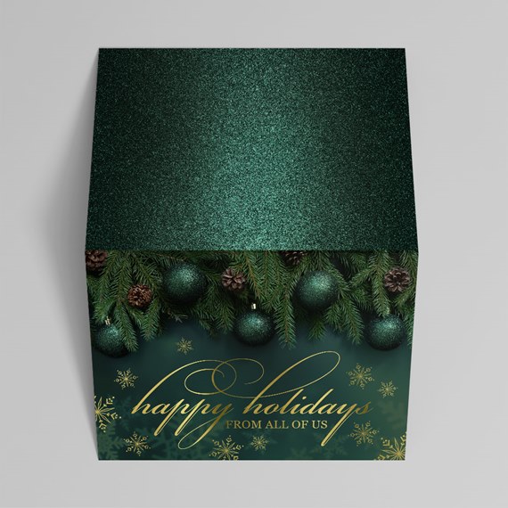 glittery holiday gift box with ornaments and pine branches