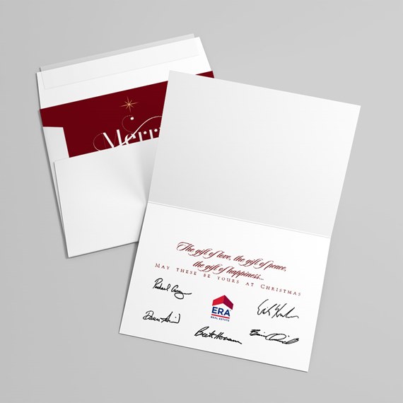 white folded holiday greeting card with red-interior envelope, printed seasonal message and signature graphics