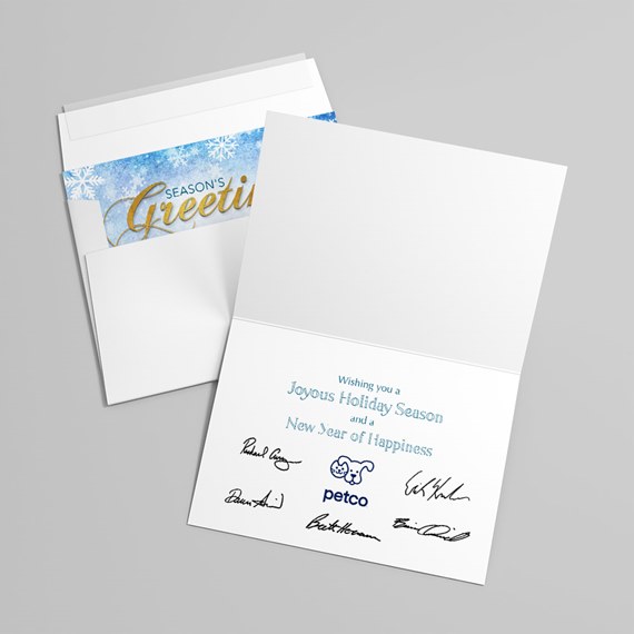 folded holiday greeting card with envelope, blue snowflake liner and gold script accent