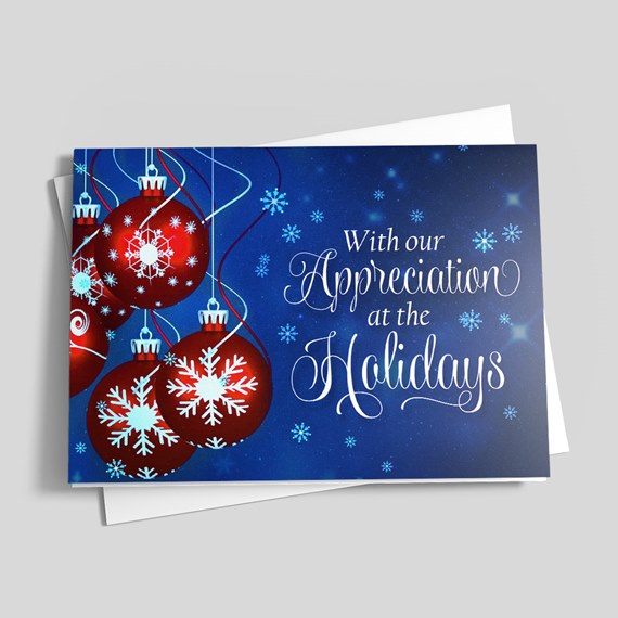 Holiday greeting card with red ornaments, white snowflakes and cursive 'With our Appreciation at the Holidays' text on a blue background