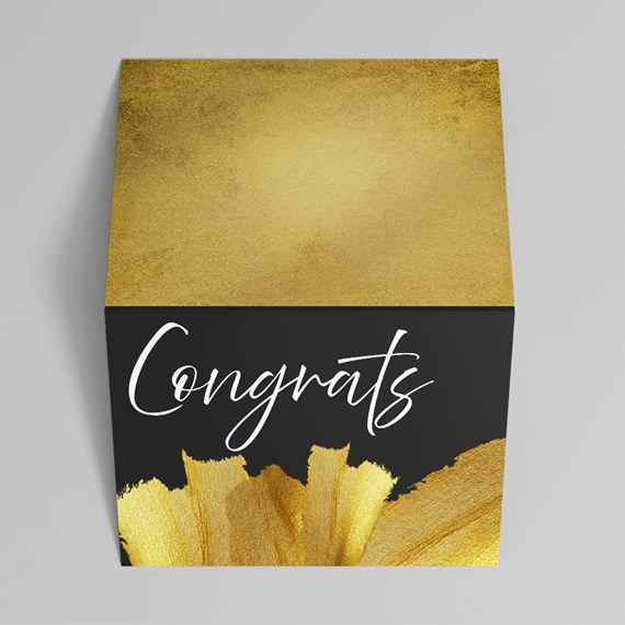 gold and black box with congrats text and brushstroke design
