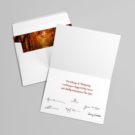 greeting card with autumn leaves design and printed text