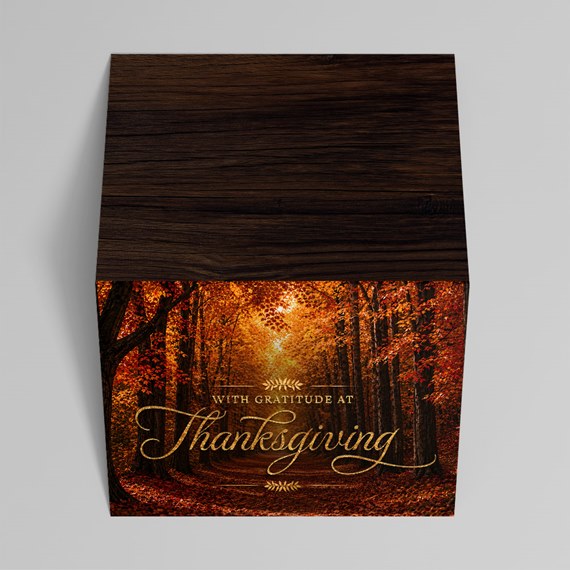 cube box with autumn forest design and gold text