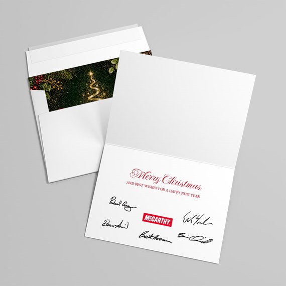 white card with red text and black signatures, green and gold inner envelope design