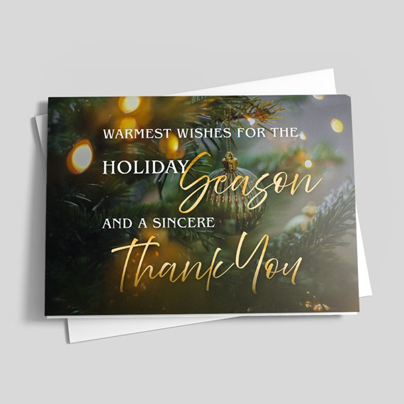 holiday greeting card with gold text and pine branches