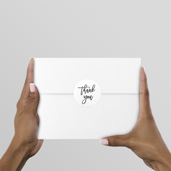 white envelope with thank you sticker
