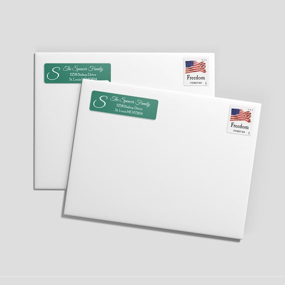 two white envelopes with address labels and postage stamp